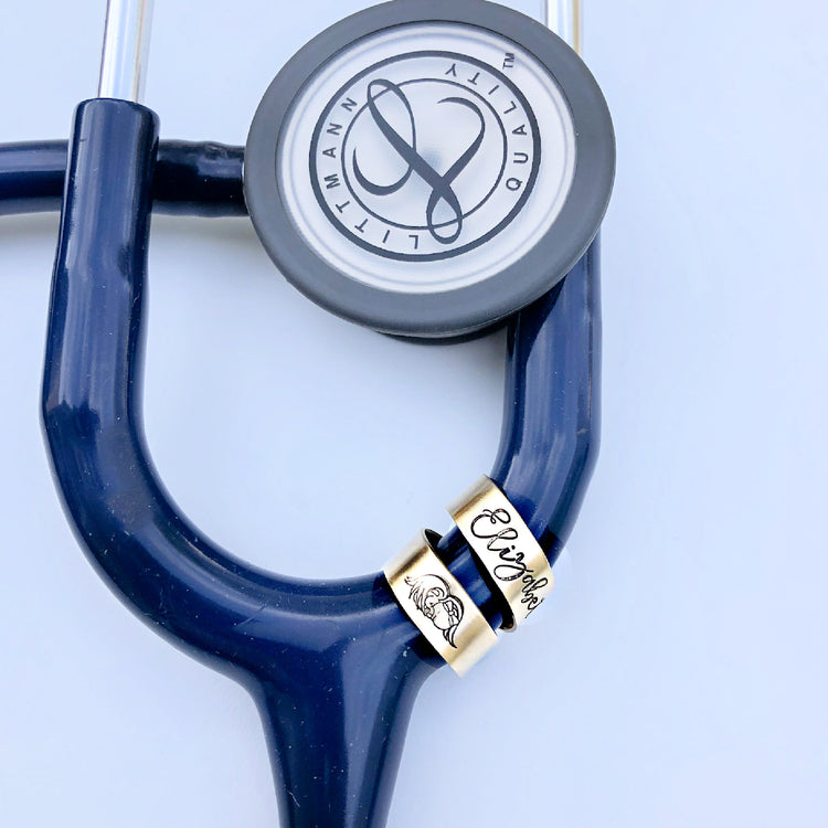 Gold double wrap stethoscope name tag with baby angel design and cursive font